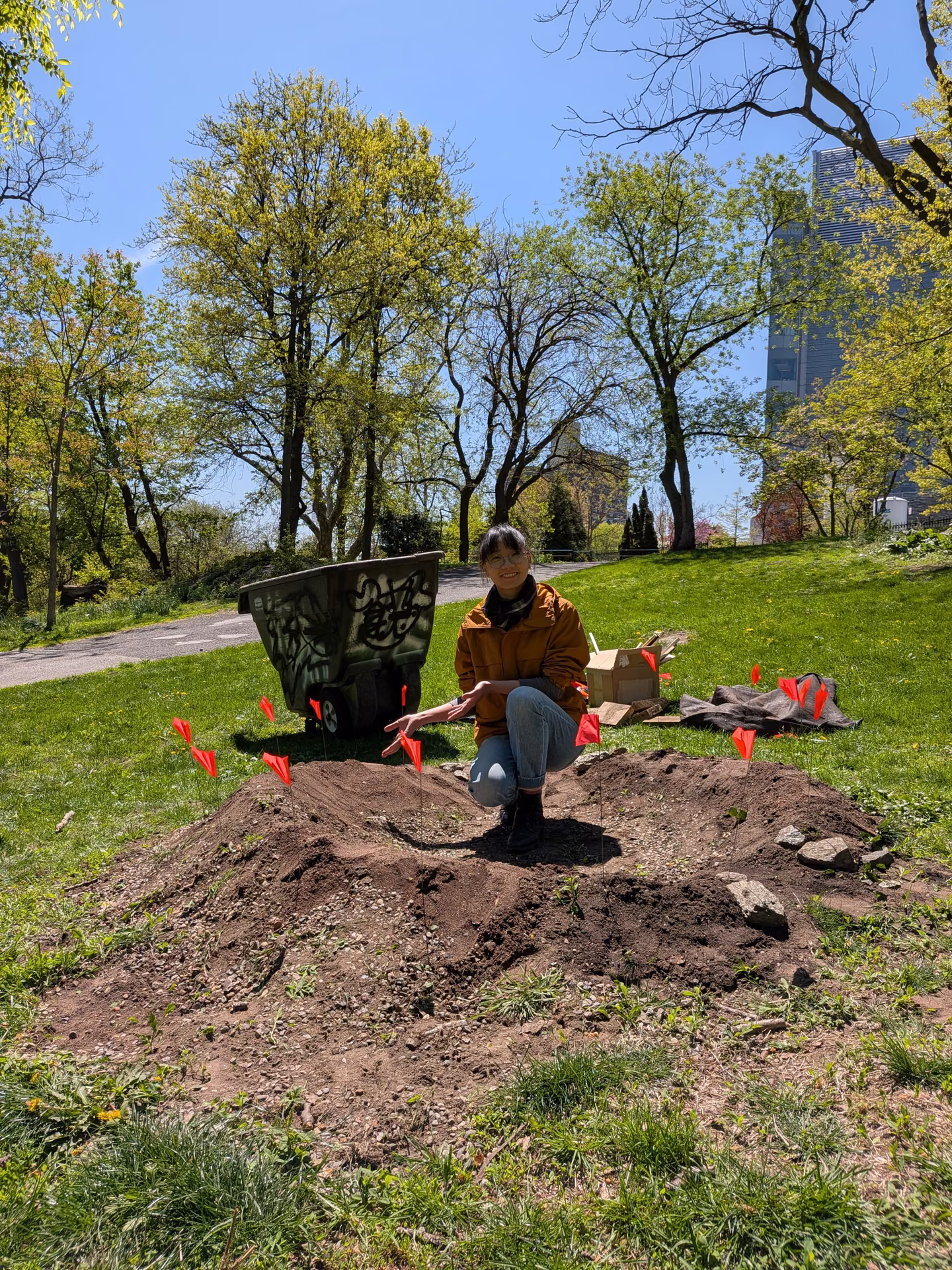 Kneeling at the edge of the turned mound