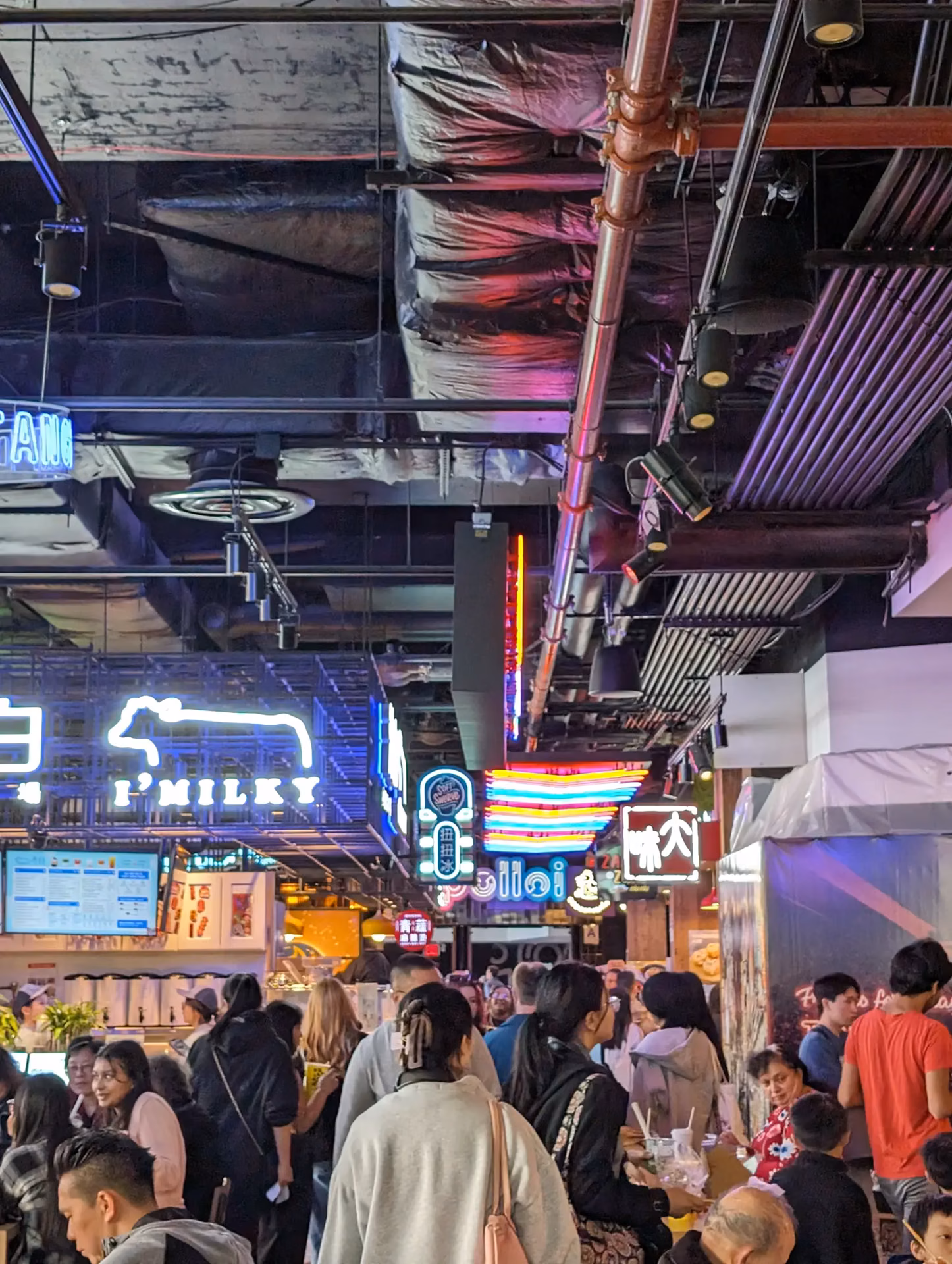 Neon-lit food court interior at Tangram