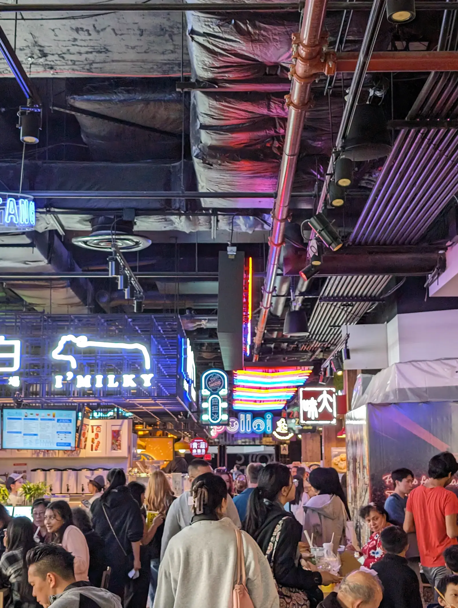 Neon-lit food court interior at Tangram