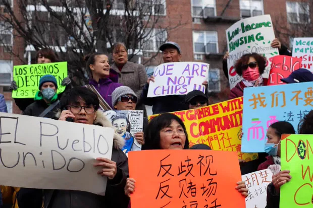 Residents protesting the Metropolitan Park casino with signs in Spanish, Chinese and English