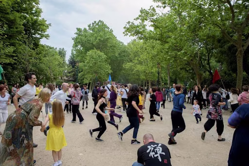 People enacting the score, moving through a park